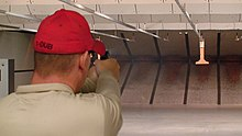 Indoor firing range showing walls, ceiling baffles, and bullet trap